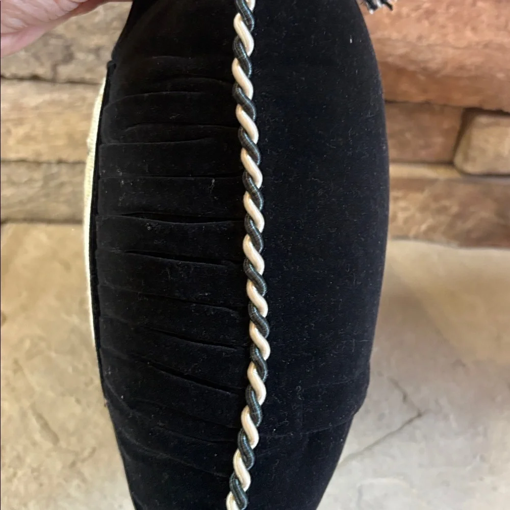 Needlepoint shoe and black velvet pillow with tassels